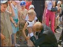 President Putin kissing boy